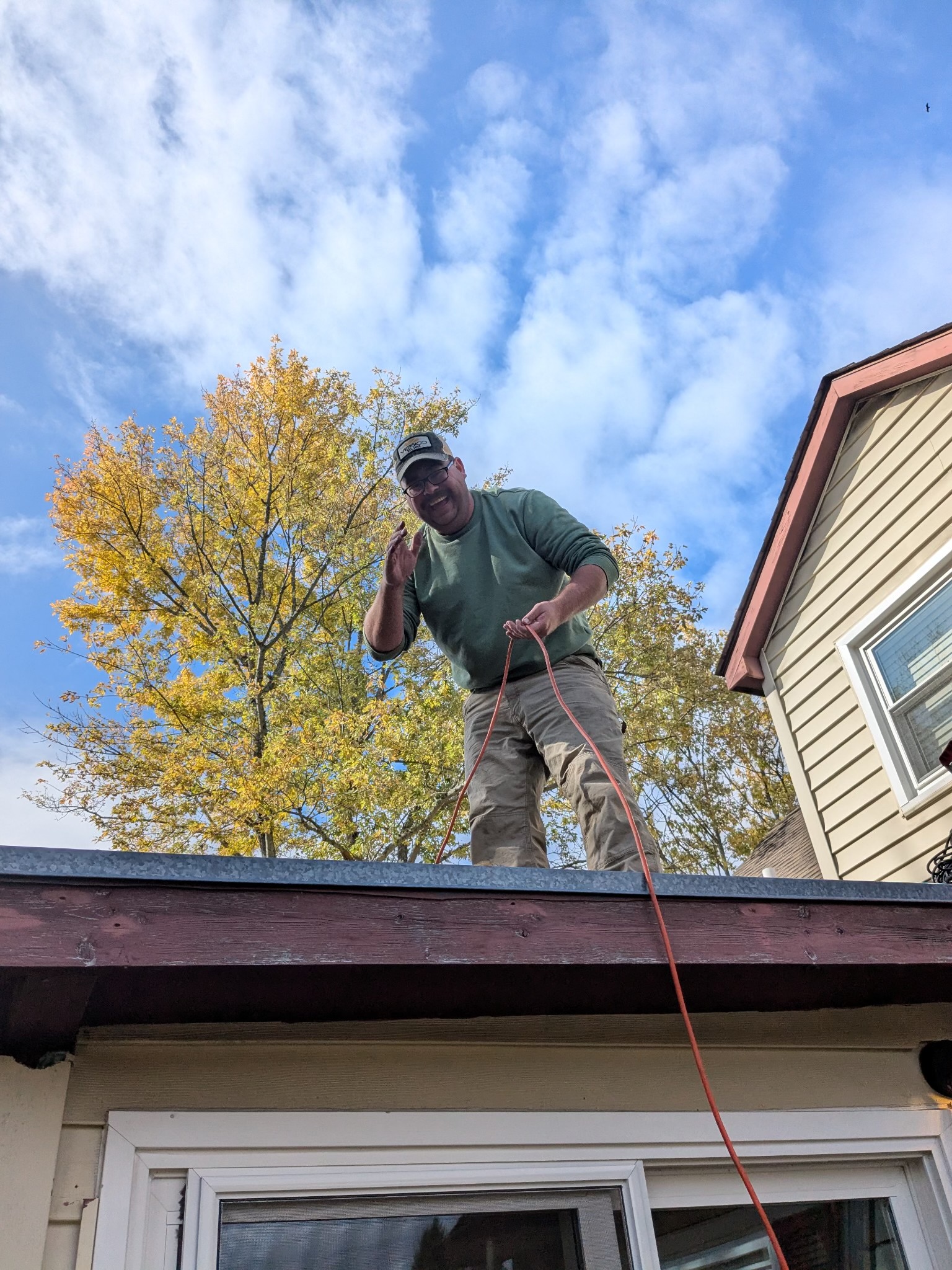 Owner of Safe and Sound Home Solutions working on a residential rooftop